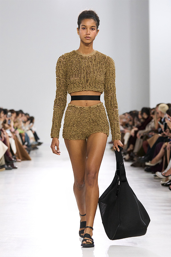 Max-Mara-Show Frühjahr/Sommer 2026 – Look mit Cropped-Pullover, einfarbiger Shorts und schwarzer Tasche.